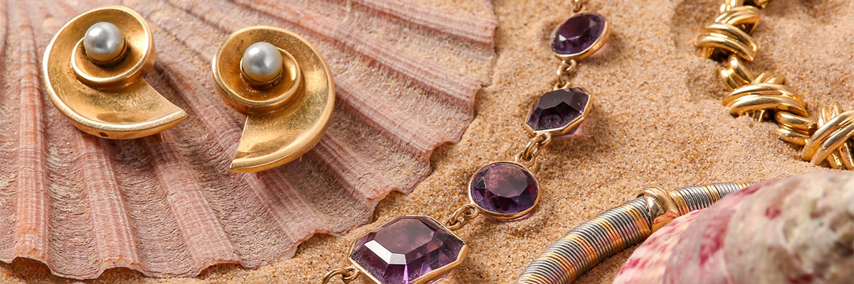 Collection of jewellery in the sand 